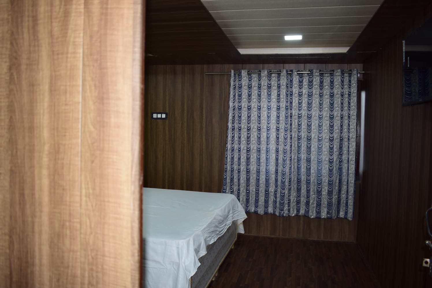 Cozy bedroom with warm wooden interiors and curtains