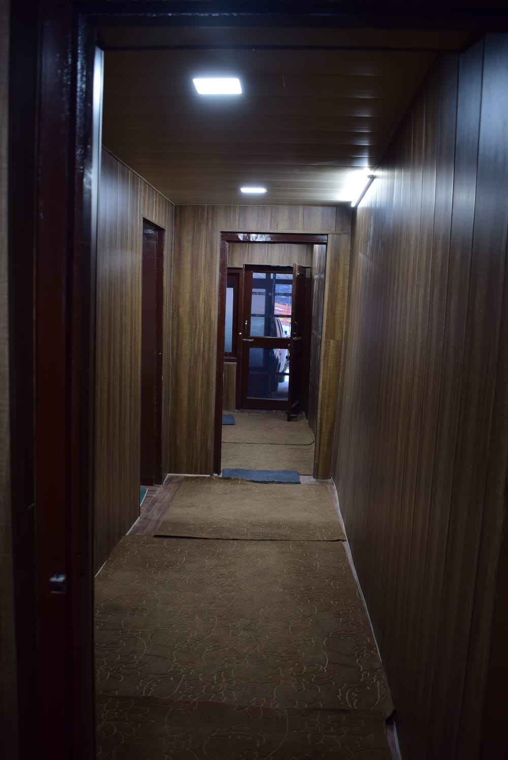 Well-lit hallway with warm wooden panelling
